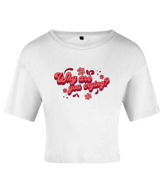 A white crop top with the text 'Why are you crying?' written in a bold red font, accented with red flowers. On a white backdrop.